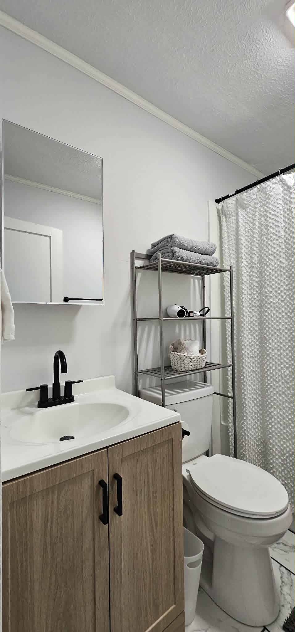 Bathroom with modern vanity and black fixtures