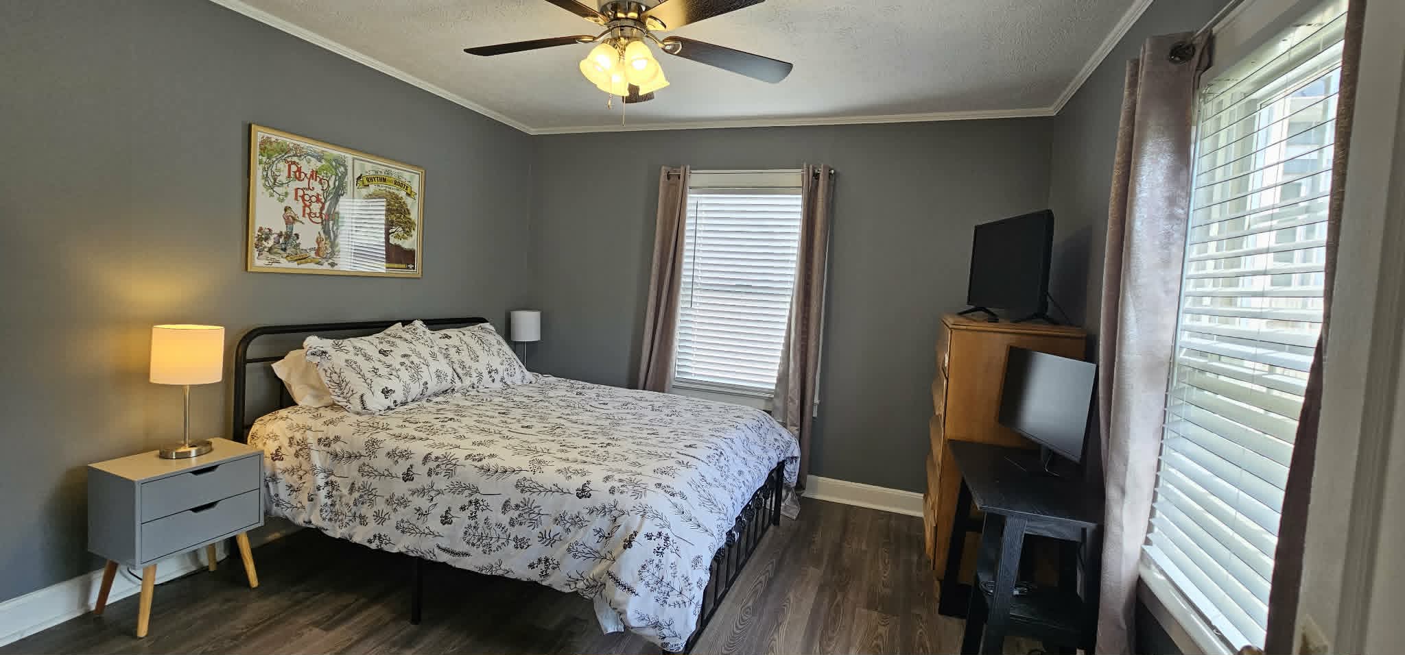 Bedroom with queen bed, nightstands, and TV