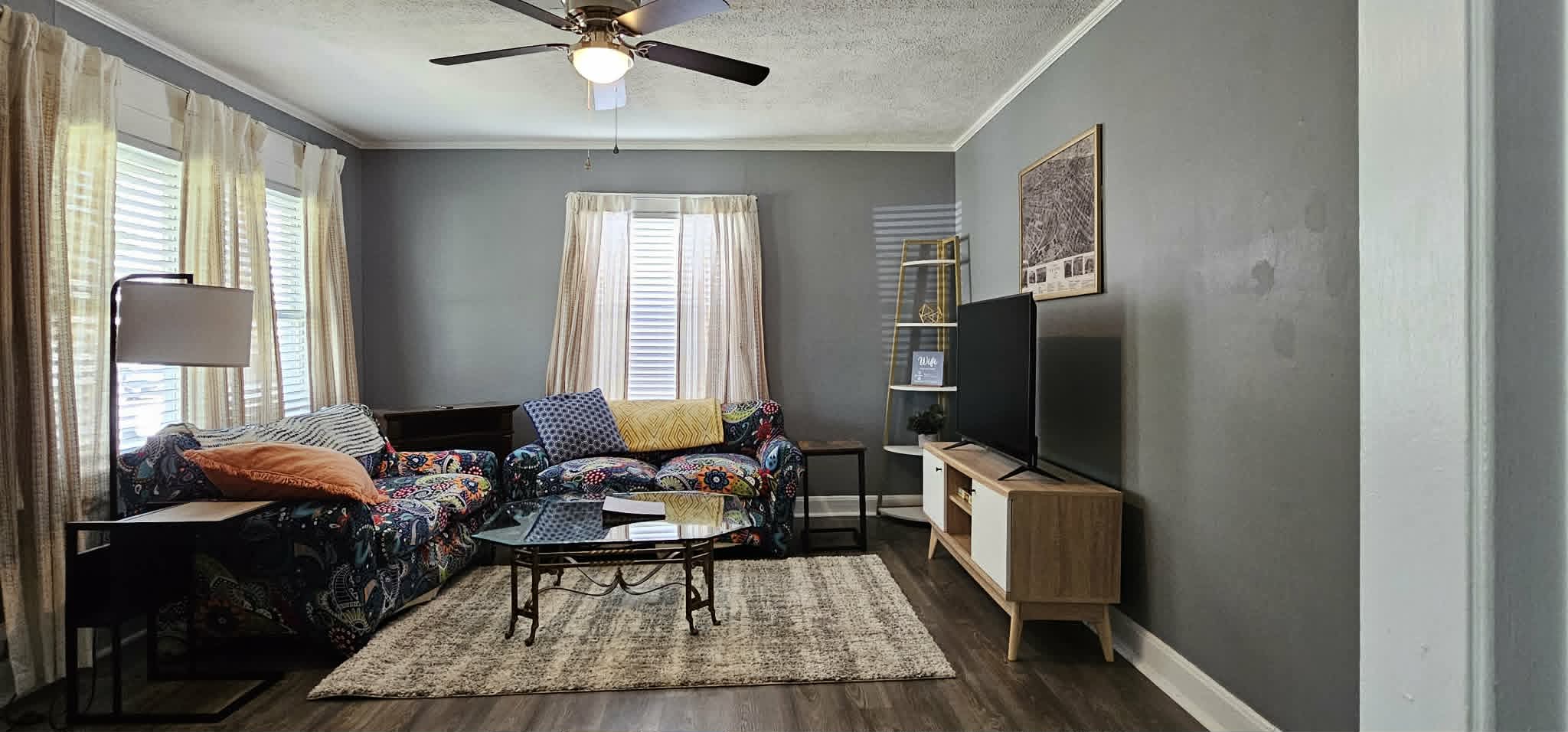 Living room with sectional sofa, TV, and natural light