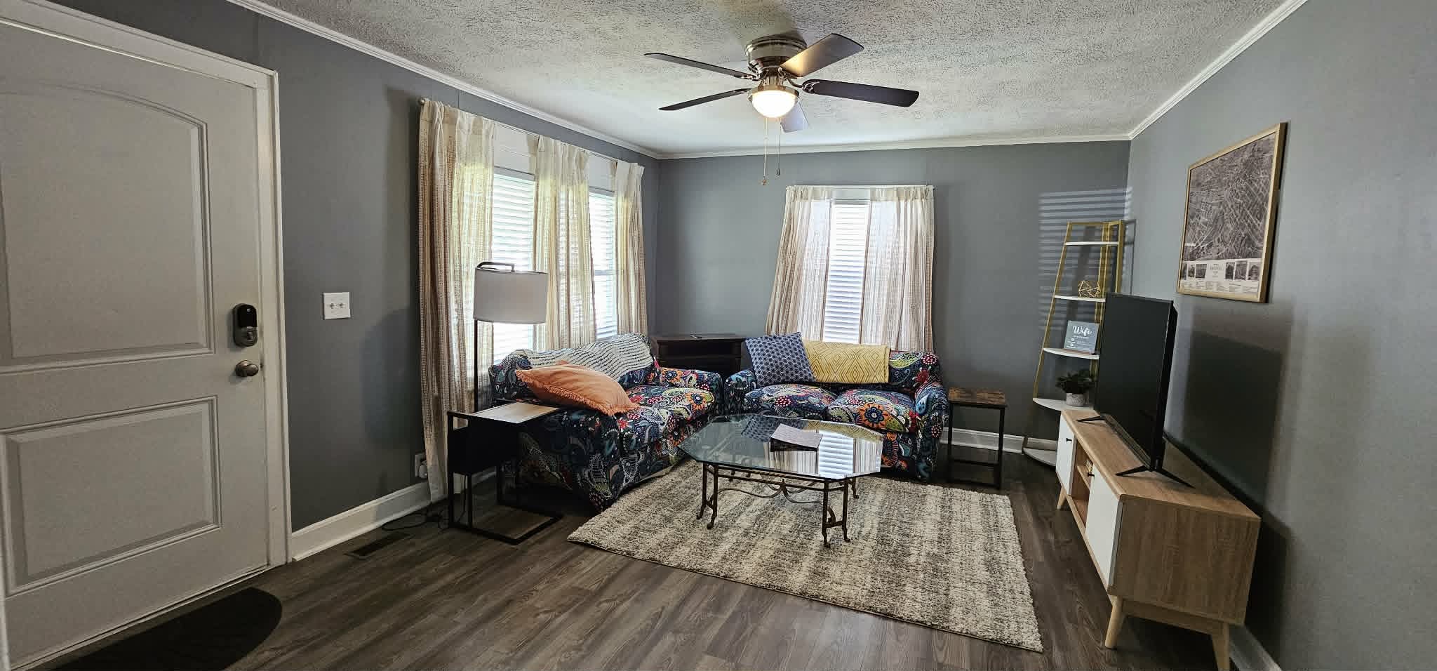 Living room with colorful sectional sofa and large TV